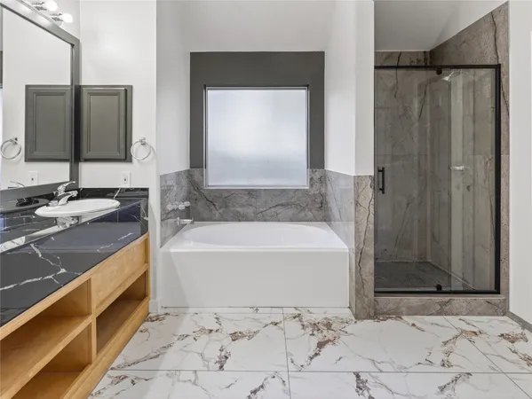 a bathroom with a bathtub and a sink