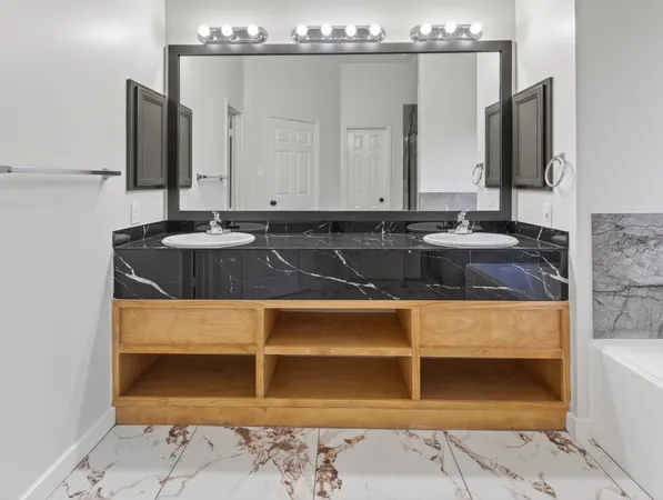 a bathroom with a sink and a mirror