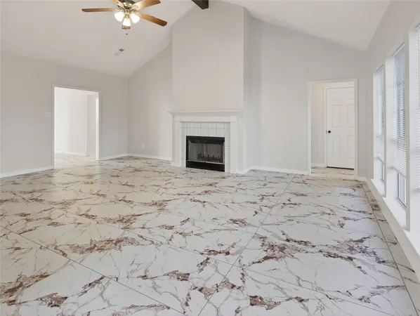 a view of empty room with a fireplace