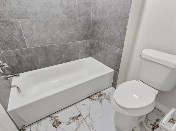 a view of empty room with window and fireplace