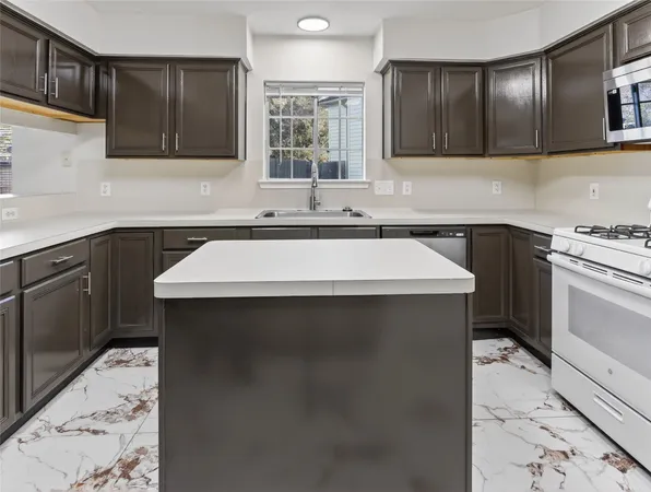 a kitchen with a sink stove and cabinets