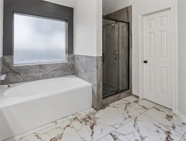 a bathroom with a bathtub and shower