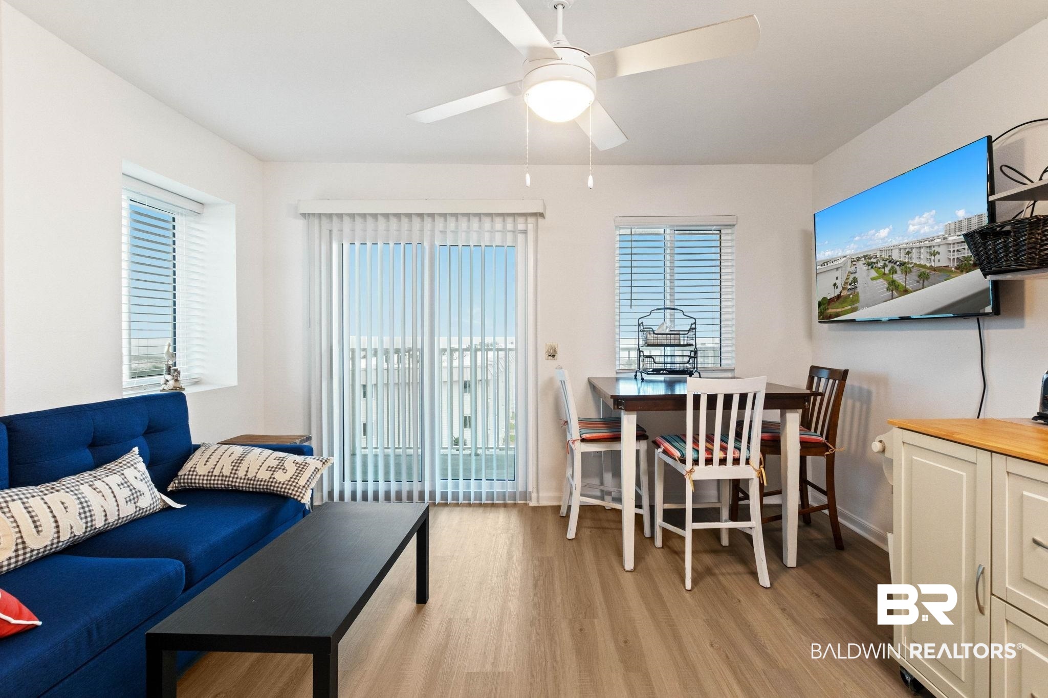 400 Plantation Road, Unit 4501 Gulf Shores, AL 36542 - Photo 6 of 30 Open-concept living space featuring wood-finish flooring and white walls