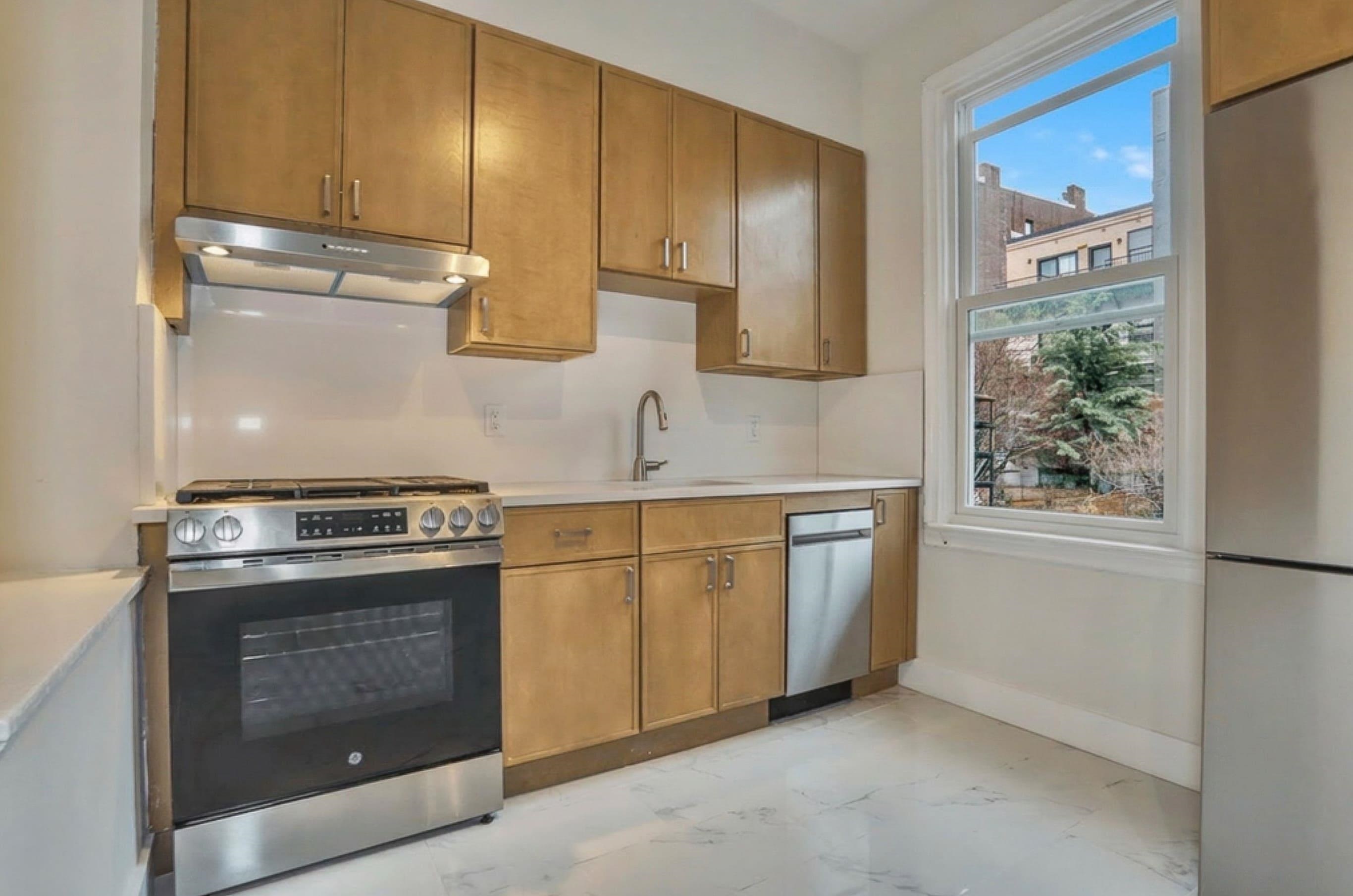 232 Garden Street, Unit 2 Hoboken, NJ 07030 - Photo 1 of 24 a kitchen with granite countertop a stove sink and cabinets