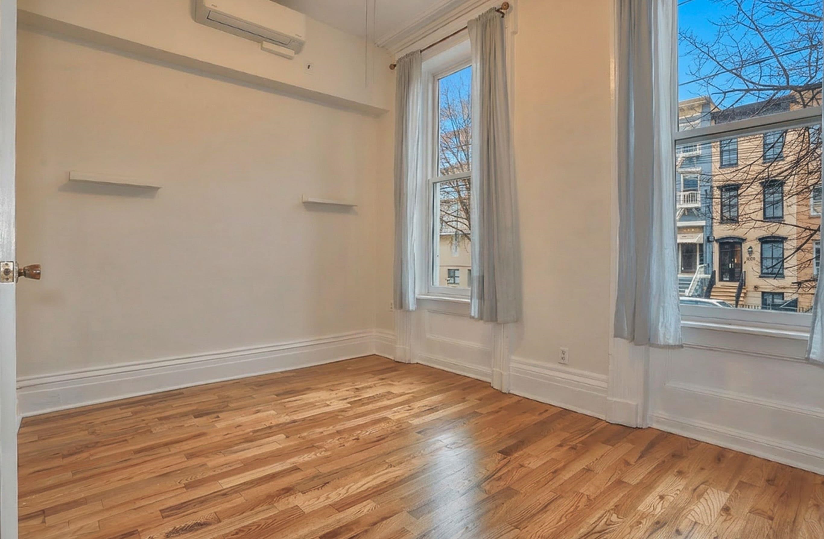 232 Garden Street, Unit 2 Hoboken, NJ 07030 - Photo 17 of 24 a view of empty room with wooden floor and fan