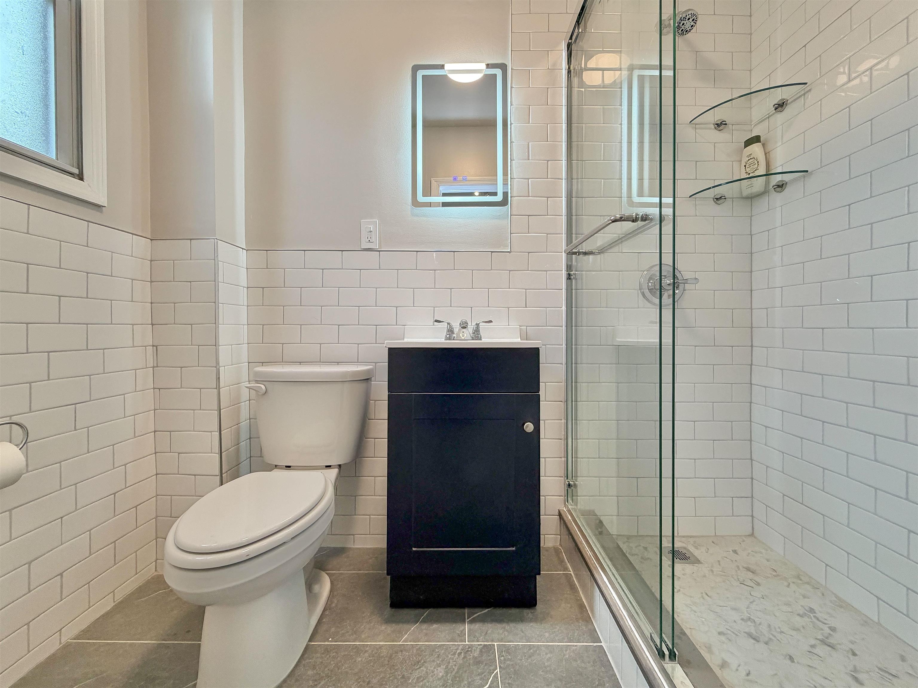 232 Garden Street, Unit 2 Hoboken, NJ 07030 - Photo 19 of 24 a bathroom with a toilet and a sink