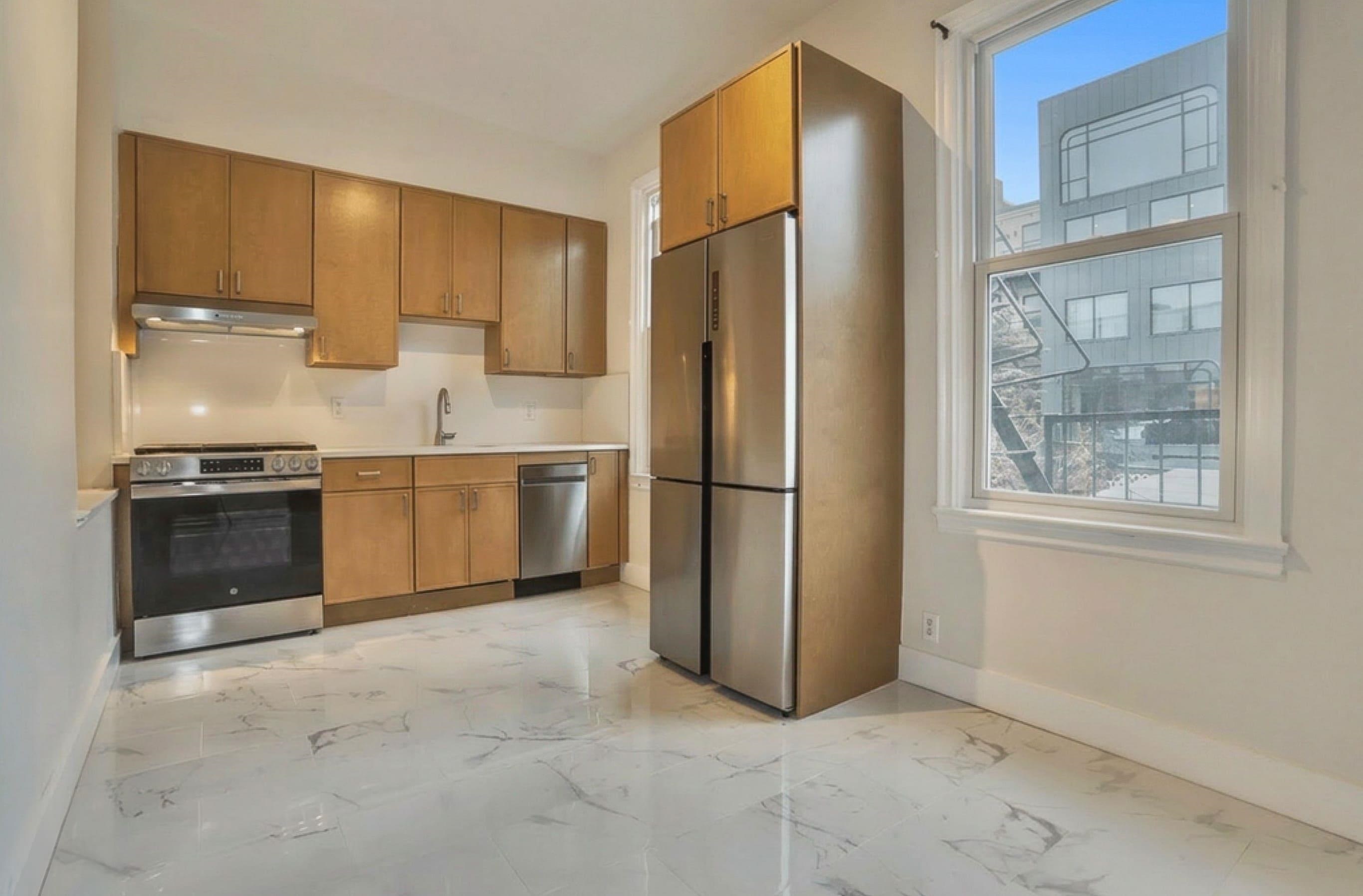 232 Garden Street, Unit 2 Hoboken, NJ 07030 - Photo 2 of 24 a kitchen with stainless steel appliances granite countertop a refrigerator a sink a stove and cabinets