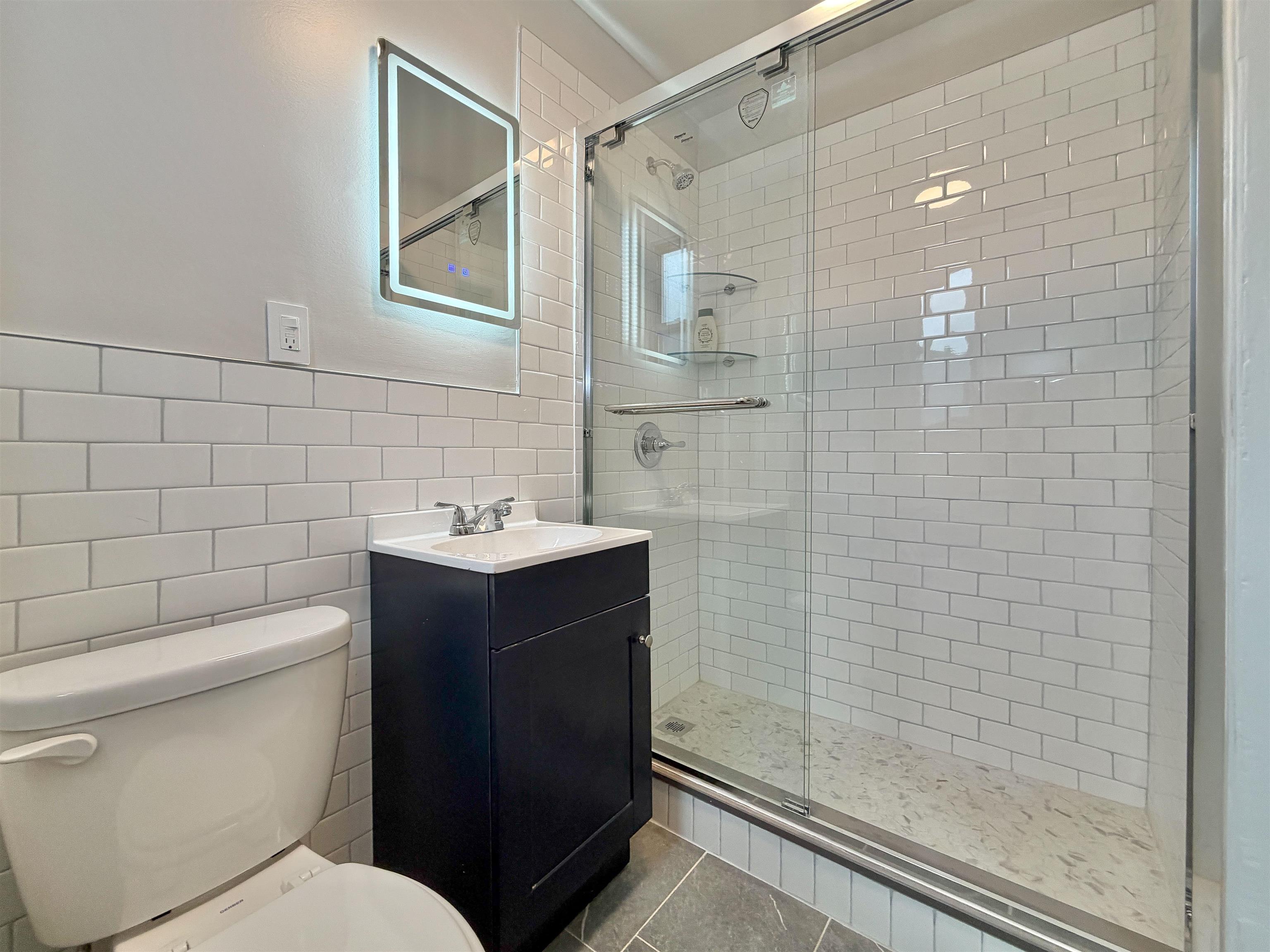 232 Garden Street, Unit 2 Hoboken, NJ 07030 - Photo 21 of 24 a bathroom with a sink toilet and shower