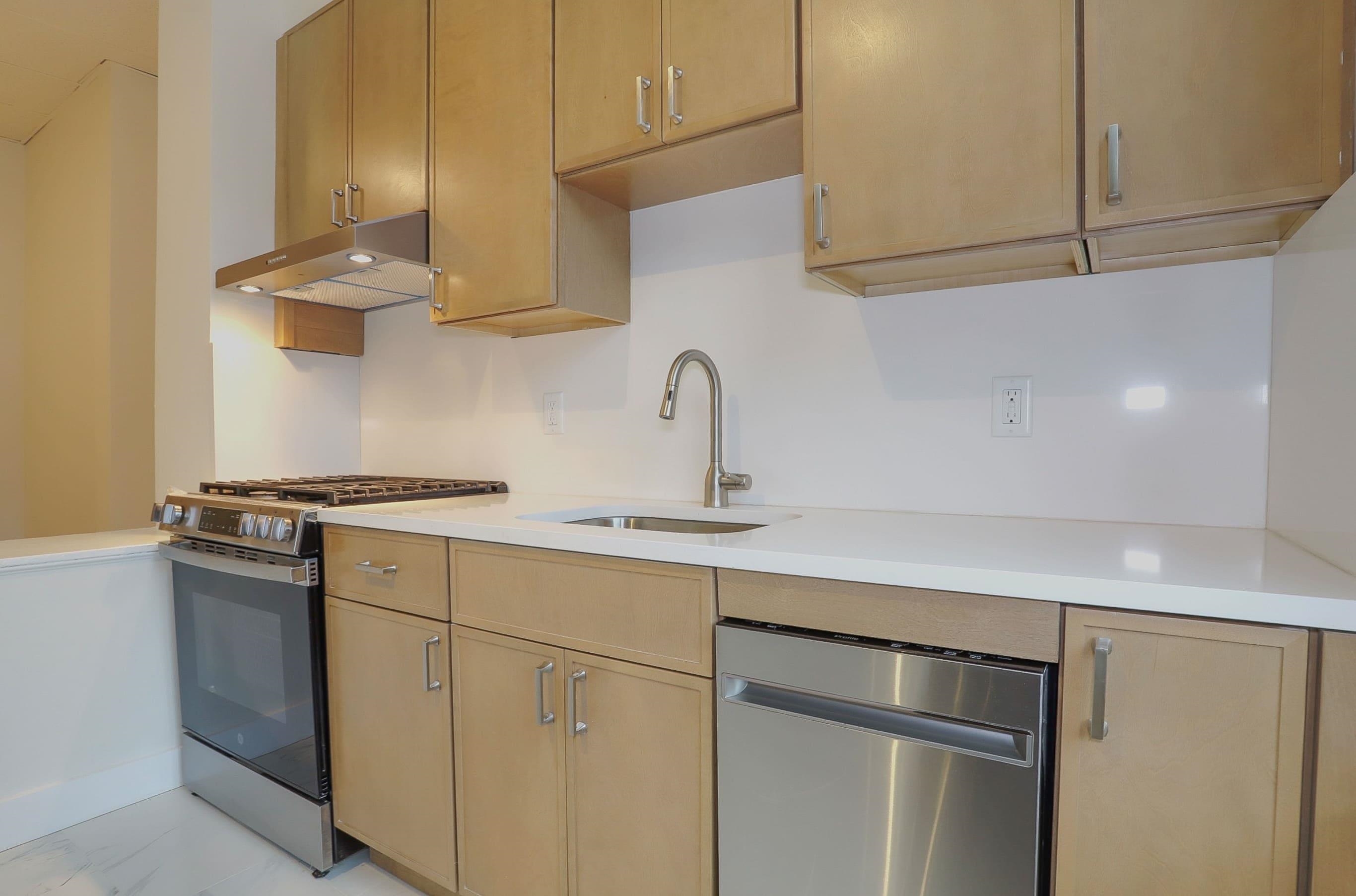 232 Garden Street, Unit 2 Hoboken, NJ 07030 - Photo 3 of 24 a kitchen with stainless steel appliances granite countertop a sink and a white cabinets