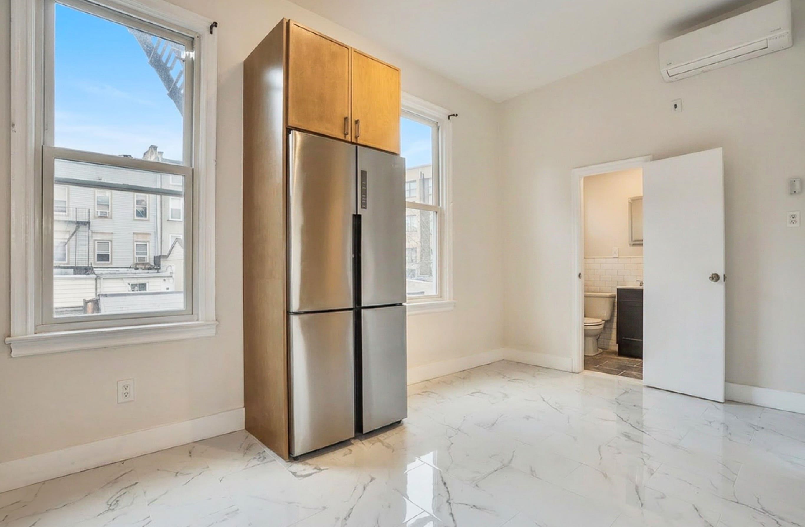 232 Garden Street, Unit 2 Hoboken, NJ 07030 - Photo 4 of 24 a view of kitchen with furniture and refrigerator