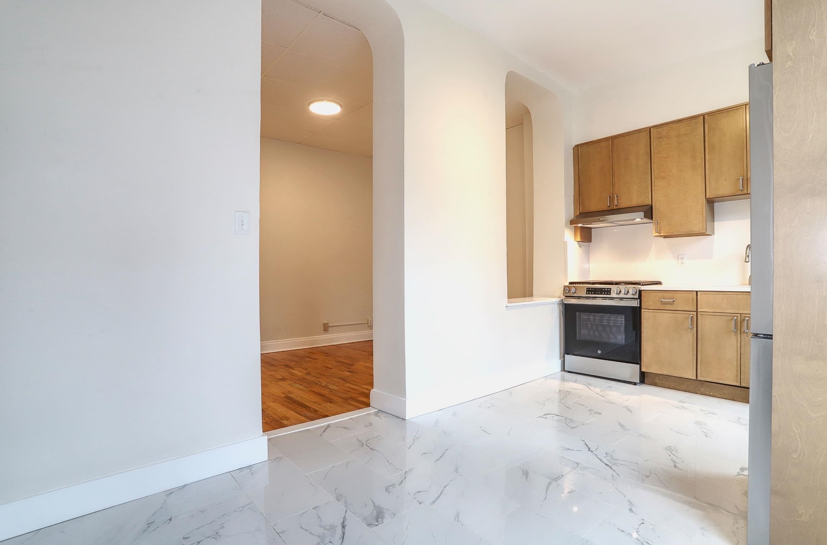 232 Garden Street, Unit 2 Hoboken, NJ 07030 - Photo 7 of 24 a view of a kitchen with a sink and a refrigerator