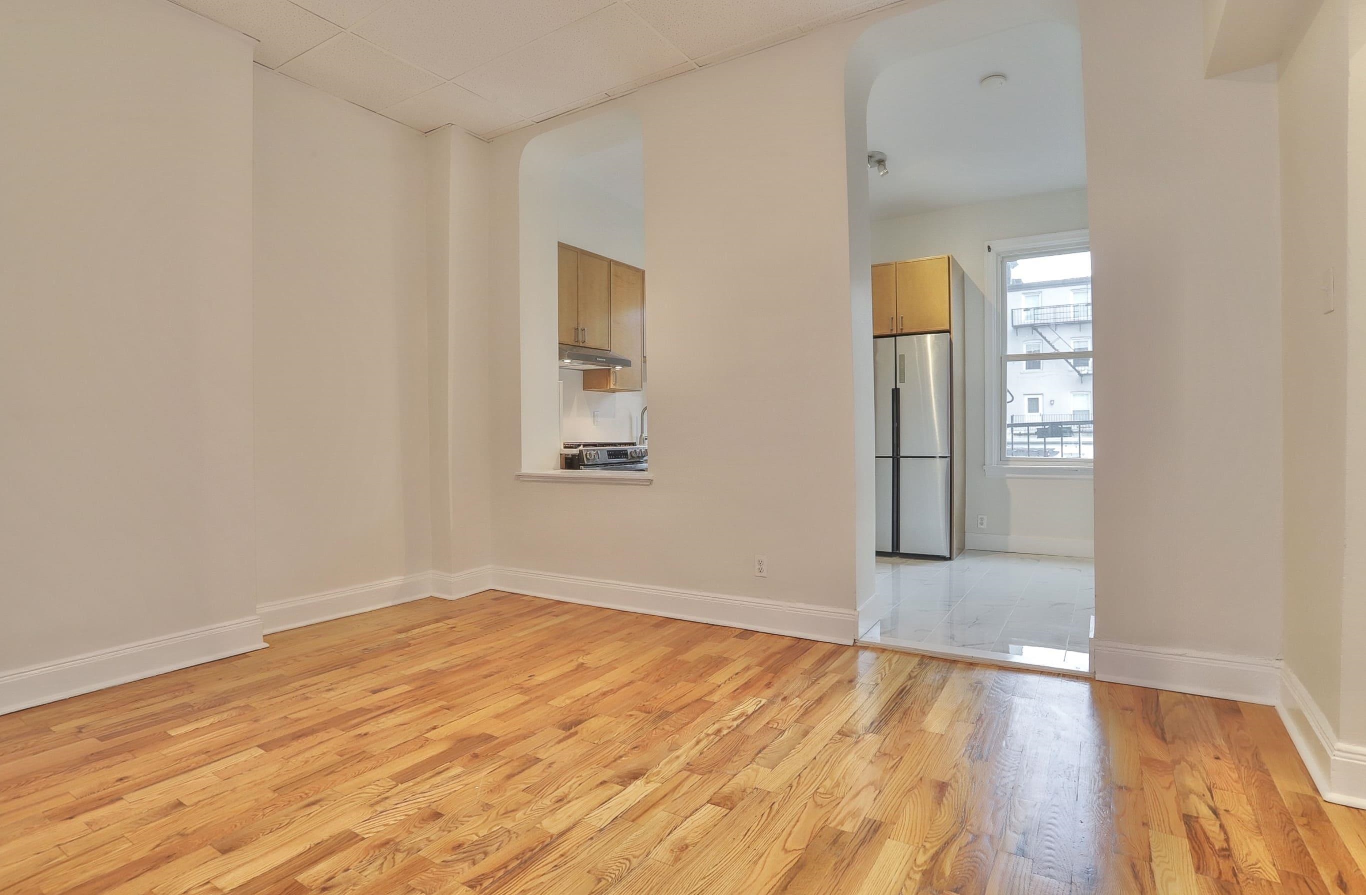 232 Garden Street, Unit 2 Hoboken, NJ 07030 - Photo 9 of 24 an empty room with wooden floor and windows