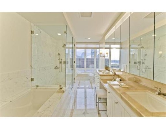 400 Stuart Street, Unit 21AA Boston, MA 02116 - Photo 11 of 22 a bathroom with a tub sink shower and a mirror