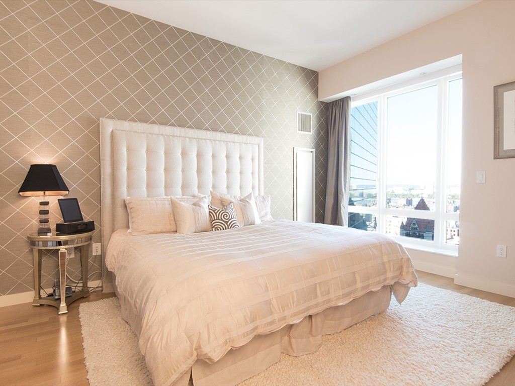 400 Stuart Street, Unit 21AA Boston, MA 02116 - Photo 12 of 22 a bedroom with a bed and wooden floor