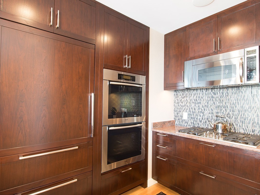 400 Stuart Street, Unit 21AA Boston, MA 02116 - Photo 6 of 22 a kitchen with granite countertop a refrigerator and a sink