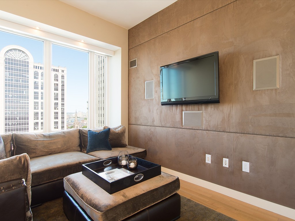 400 Stuart Street, Unit 21AA Boston, MA 02116 - Photo 8 of 22 a living room with furniture and a flat screen tv