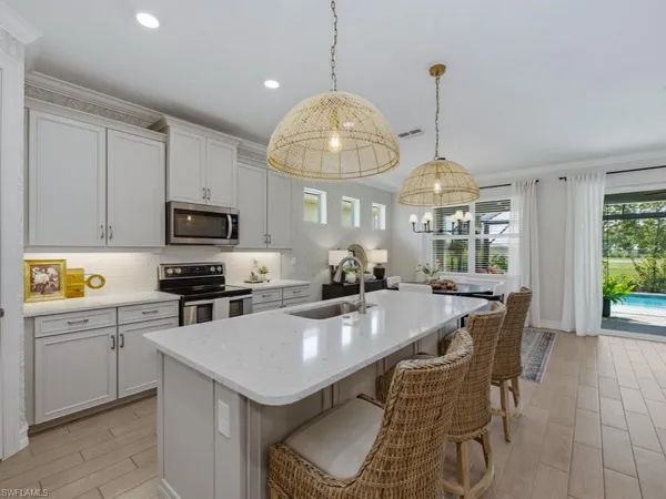 a kitchen with stainless steel appliances granite countertop a stove a kitchen island a stove and a cabinets