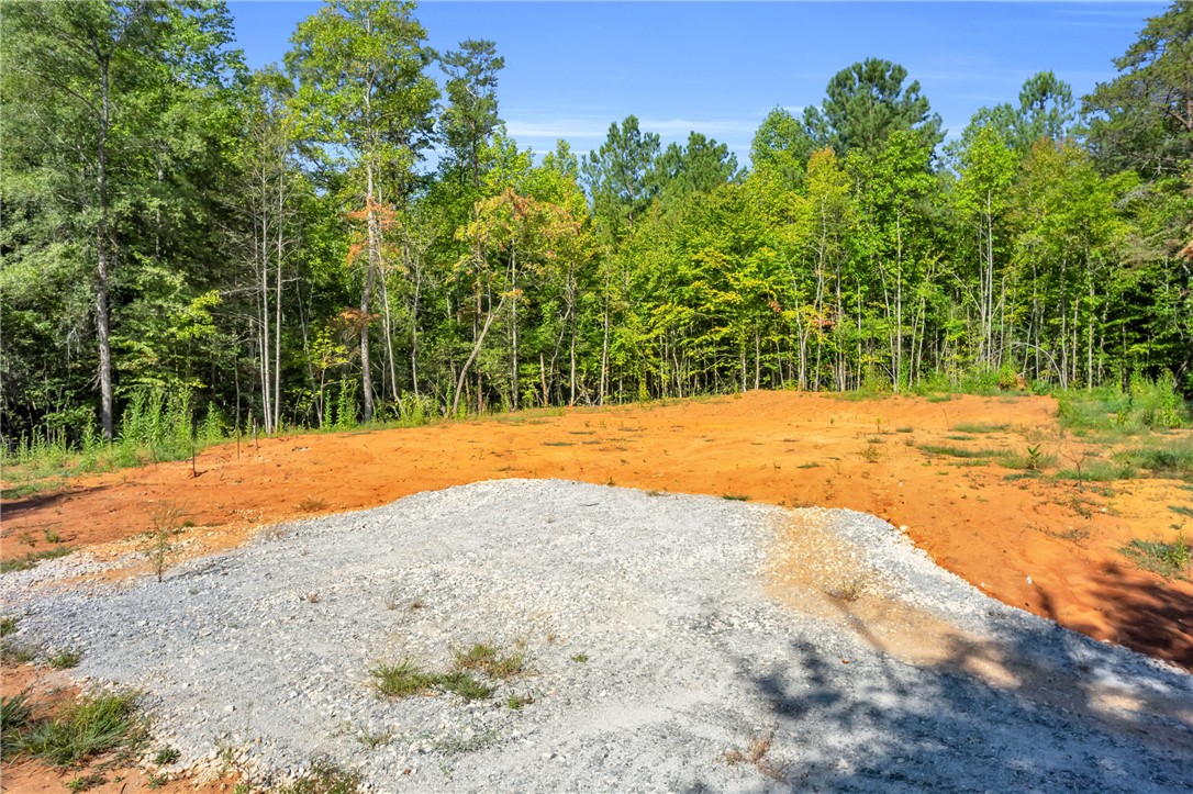 167 Cherokee Trail Easley, SC 29640 - Photo 2 of 18 A spacious lot ready for development, featuring a gravel base and surrounded by mature woodlands.