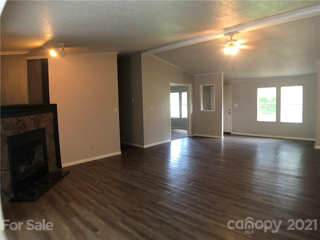 5526 Whiteside Road Bostic, NC 28018 - Photo 11 of 48 a view of a livingroom with wooden floor and a fireplace
