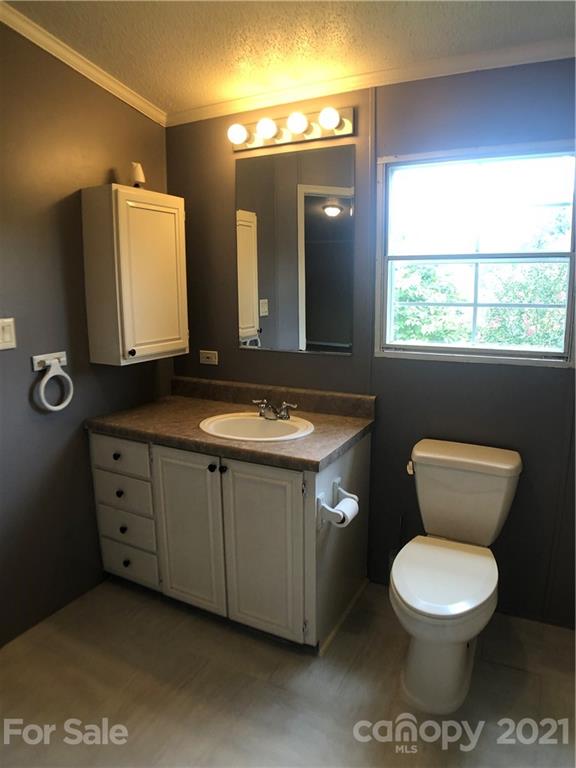 5526 Whiteside Road Bostic, NC 28018 - Photo 17 of 48 a bathroom with a toilet sink and mirror