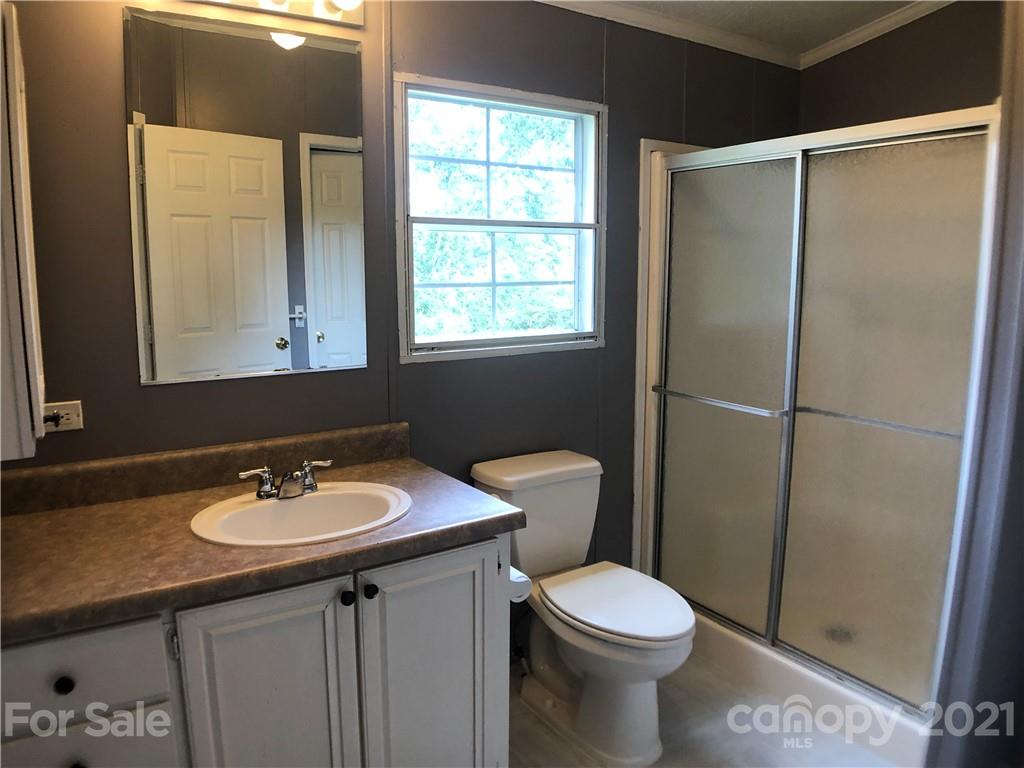 5526 Whiteside Road Bostic, NC 28018 - Photo 18 of 48 a bathroom with a sink toilet and vanity