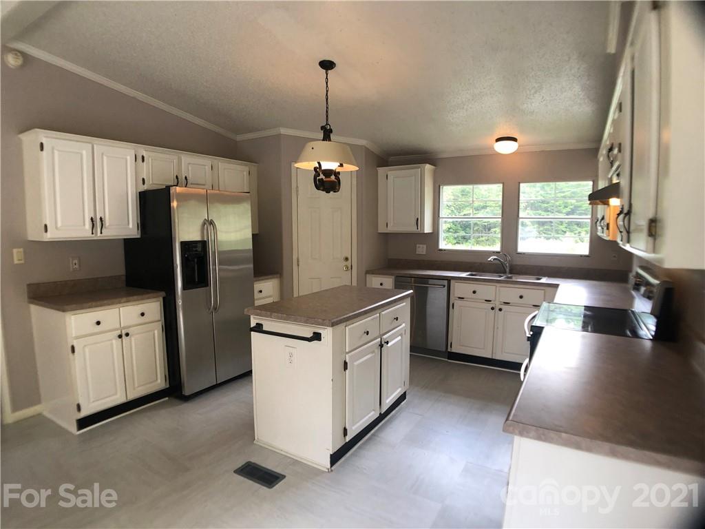 5526 Whiteside Road Bostic, NC 28018 - Photo 3 of 48 a kitchen with stainless steel appliances kitchen island granite countertop a stove a sink a refrigerator and a refrigerator