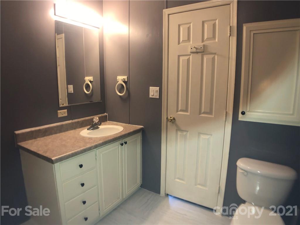 5526 Whiteside Road Bostic, NC 28018 - Photo 27 of 48 a bathroom with a sink a toilet and mirror