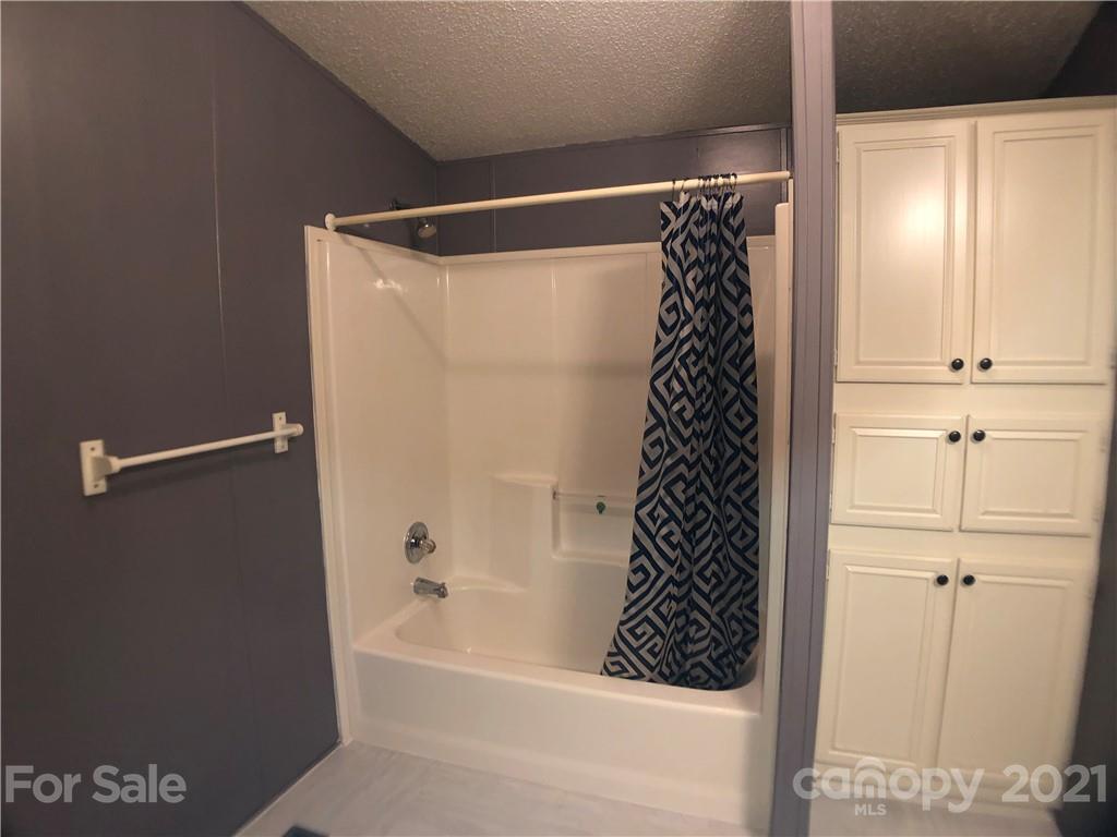5526 Whiteside Road Bostic, NC 28018 - Photo 28 of 48 a bathroom with a bathtub and a shower