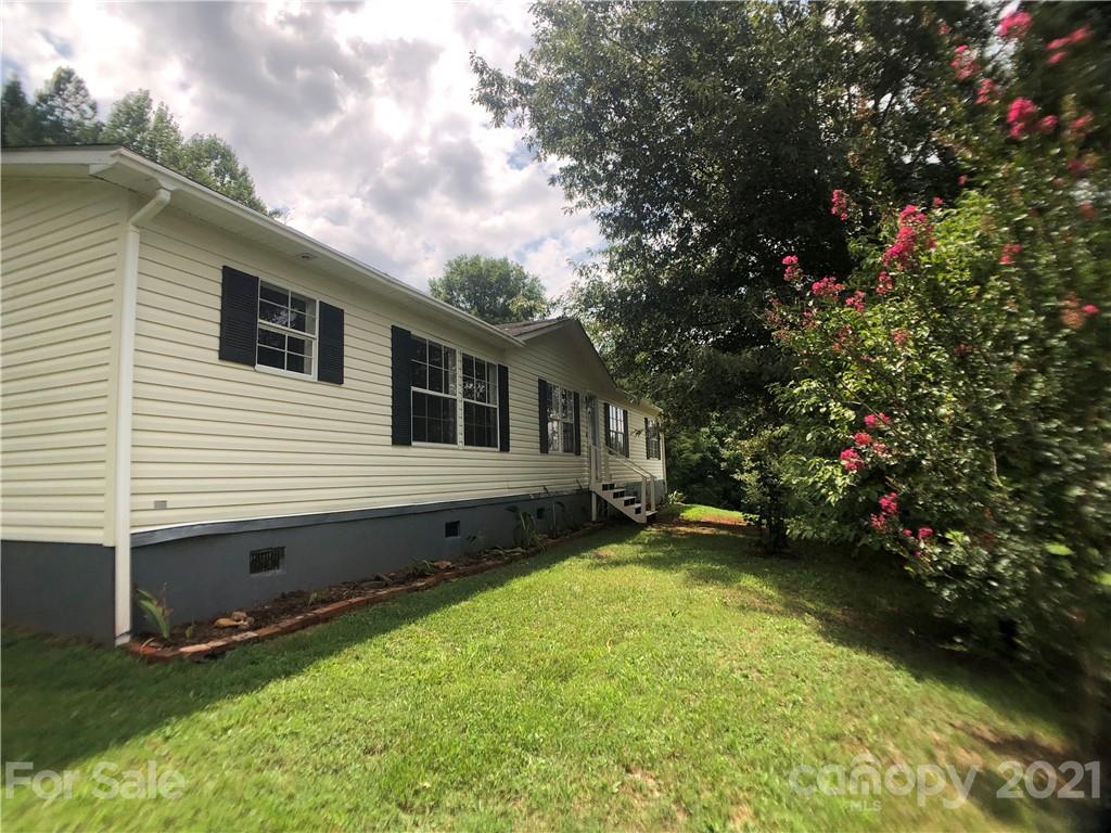 5526 Whiteside Road Bostic, NC 28018 - Photo 36 of 48 a backyard of a house with lots of green space and a fountain