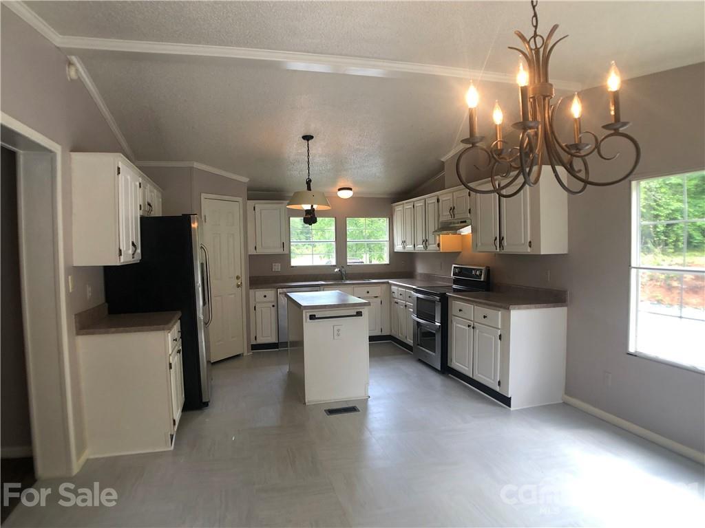 5526 Whiteside Road Bostic, NC 28018 - Photo 5 of 48 a kitchen with a refrigerator and a sink