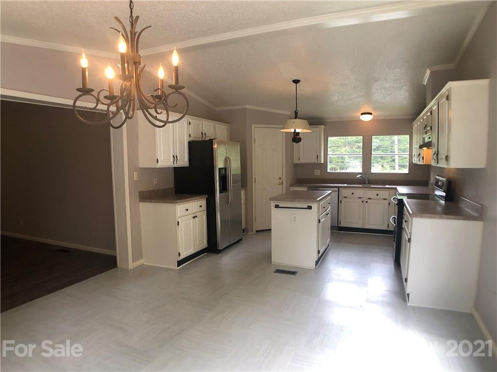 5526 Whiteside Road Bostic, NC 28018 - Photo 6 of 48 a kitchen with a refrigerator a sink and cabinets