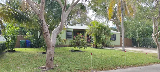 a view of a house with a tree in a yard