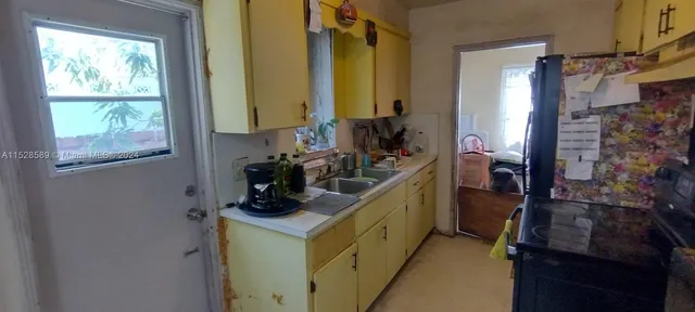 a bathroom with a sink a mirror and a window