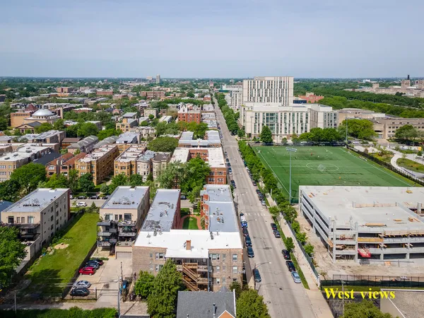 an aerial view of a house with garden space and lake view