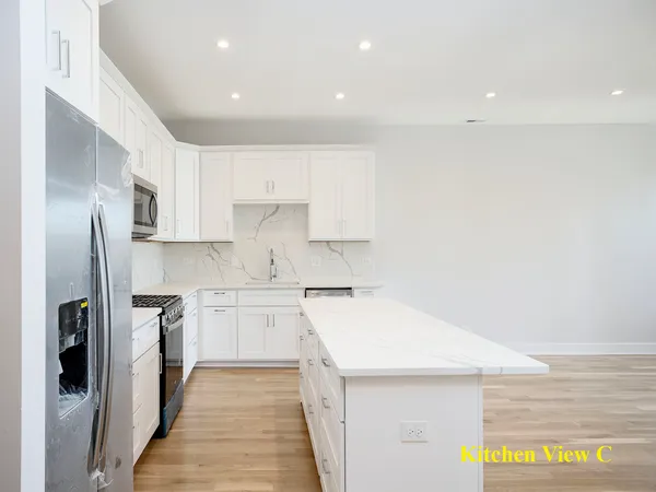 a kitchen with a sink stove and refrigerator
