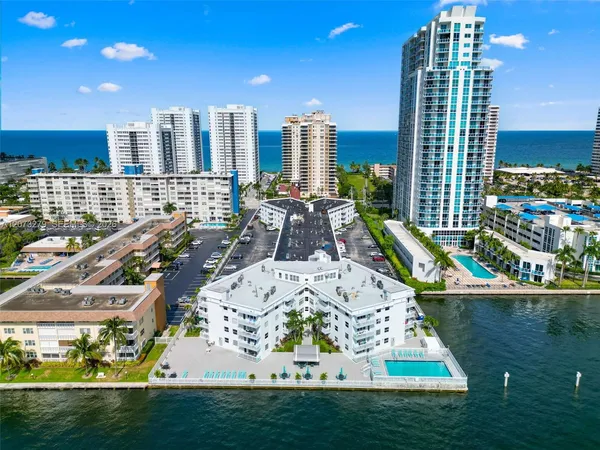 a view of swimming pool with outdoor seating and city view