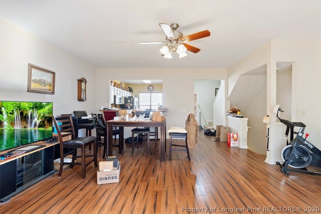 7233 Galon Glen Road Raleigh, NC 27613 - Photo 3 of 6 a view of a dining room and livingroom with furniture wooden floor a rug a painting and a chandelier