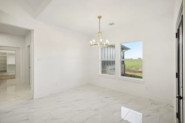 an empty room with a fireplace and painted walls