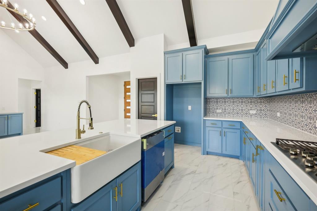 6657 Buffalo Ridge Circle Godley, TX 76044 - Photo 18 of 38 a kitchen with kitchen island granite countertop a sink stove and cabinets