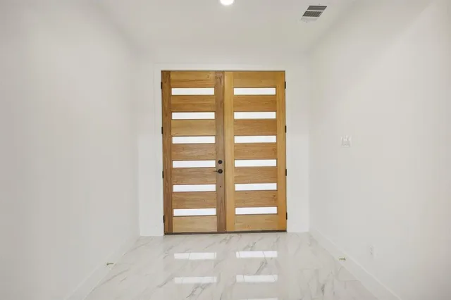 a view of an empty room with a fireplace and a window
