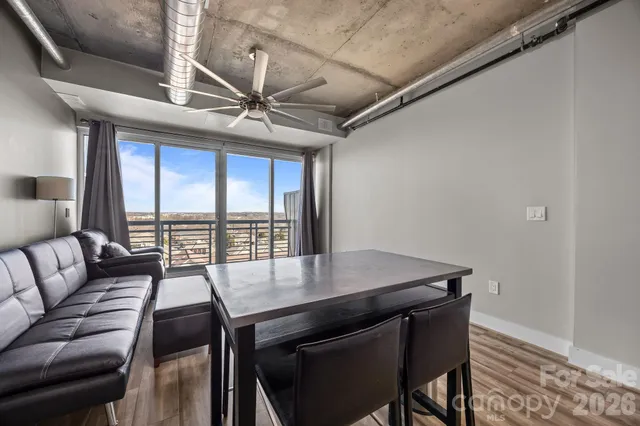 a view of a dining room with furniture large windows and wooden floor