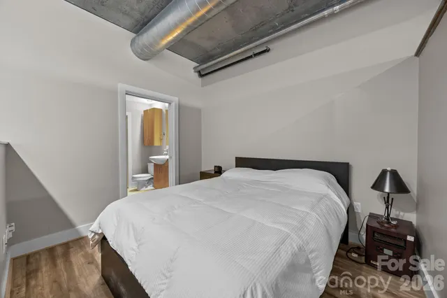 a bedroom with a bed and a mirror