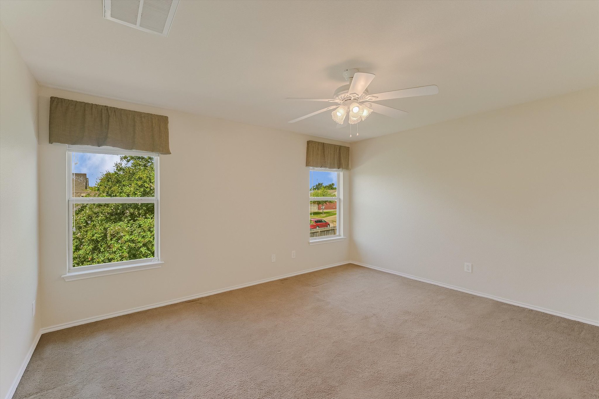 93 Verde Ranch Loop Leander, TX 78641 - Photo 12 of 20 an empty room with windows and fan