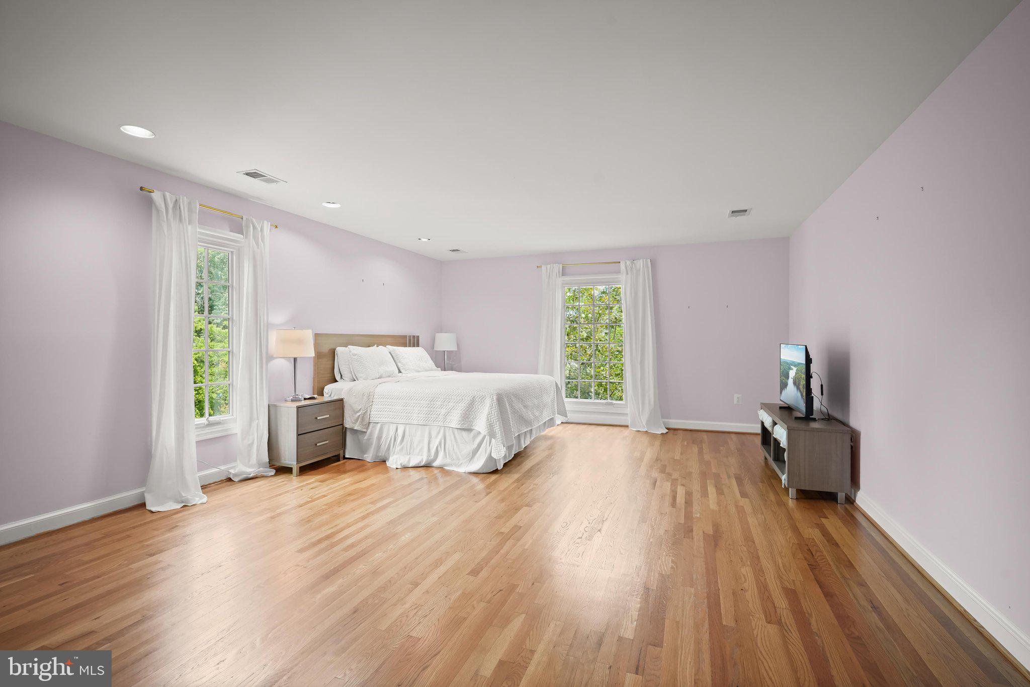 9809 Hall Road Potomac, MD 20854 - Photo 24 of 60 a bedroom with a bed and wooden floor