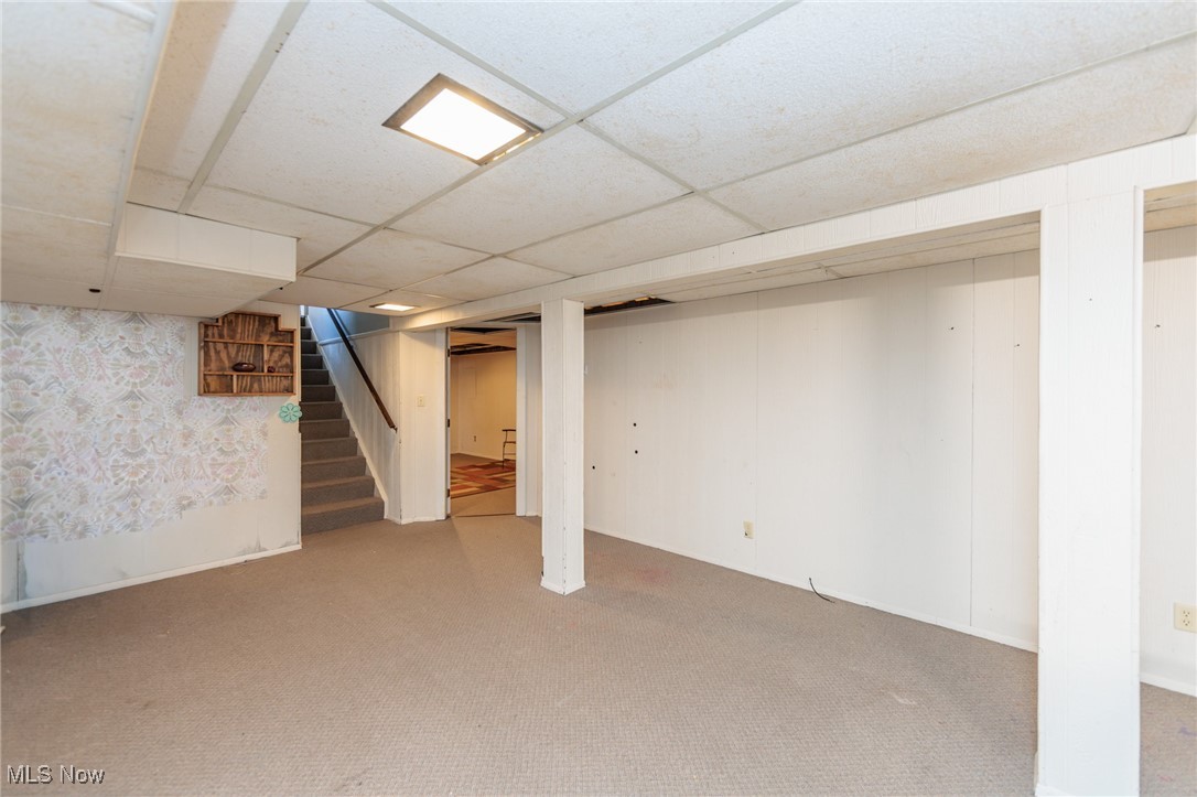 3801 Baird Road Stow, OH 44224 - Photo 20 of 31 Finished below grade area with carpet flooring, a paneled ceiling, and stairway