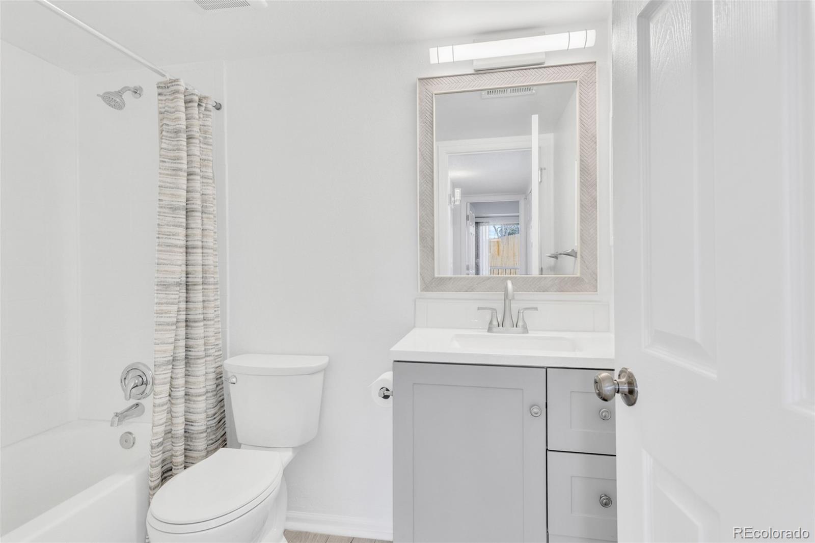 2575 South Syracuse Way, Unit J108 Denver, CO 80231 - Photo 11 of 18 a bathroom with a sink toilet and shower
