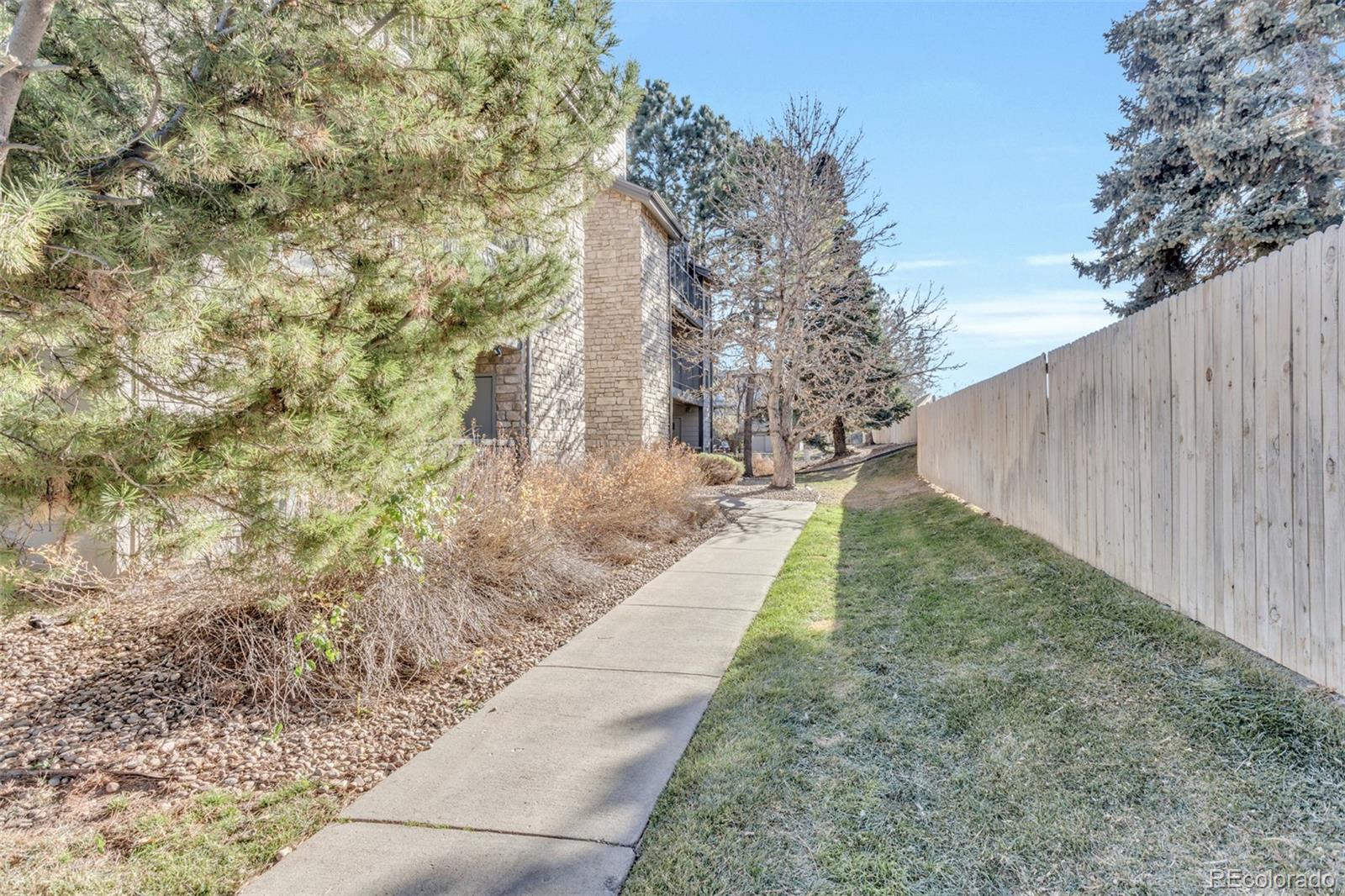 2575 South Syracuse Way, Unit J108 Denver, CO 80231 - Photo 16 of 18 a view of a backyard with pathway