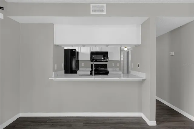 a view of kitchen with cabinets and wooden floor