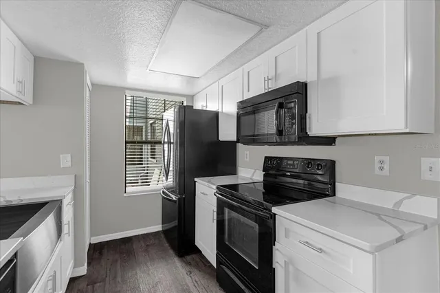 a kitchen with a stove microwave and sink