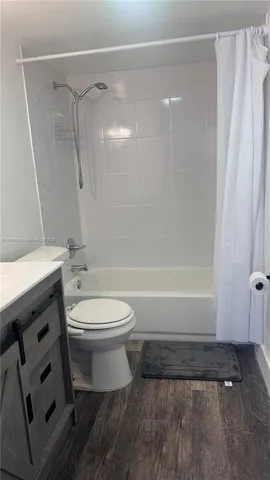 a bathroom with a toilet a sink and a shower